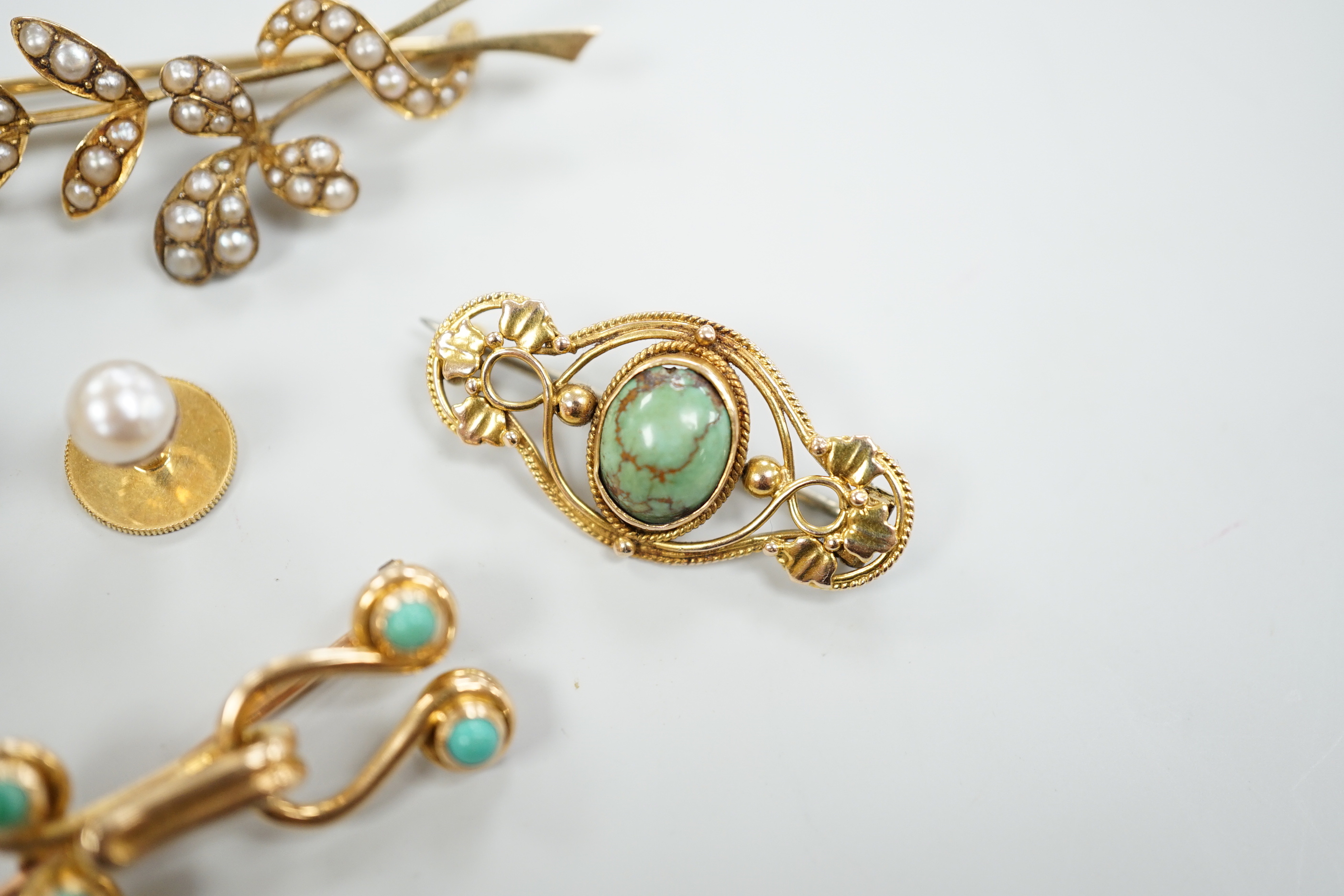 An Edwardian 15ct and seed pearl cluster set spray brooch, 47mm, a 15ct and four stone turquoise set brooch, one other yellow meta and turquoise brooch and a pair of 9ct and cultured pearl set dress studs.